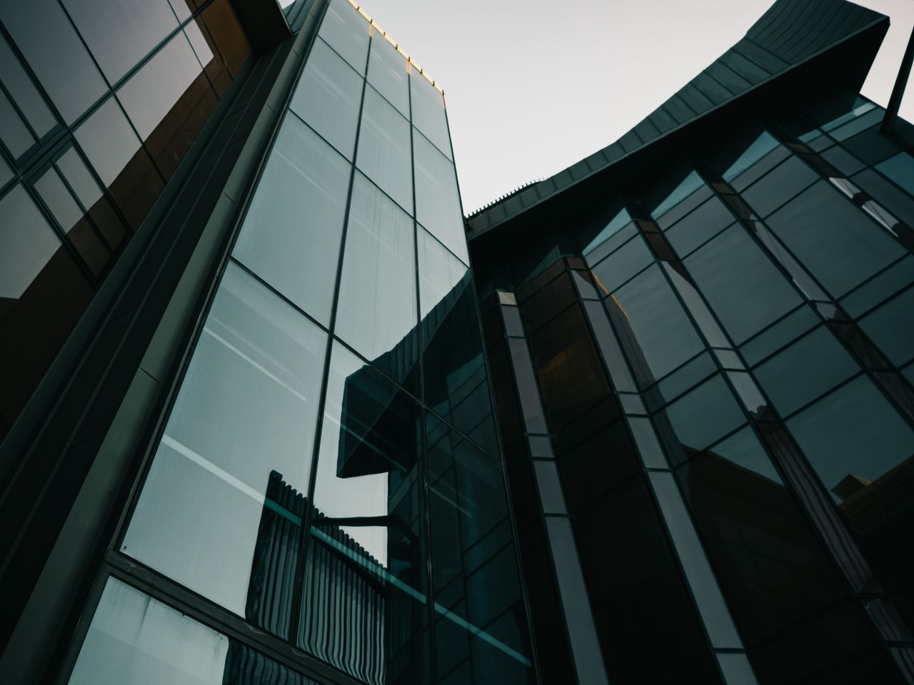 A striking view of modern glass building facades in an urban environment, showcasing contemporary architecture.
